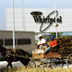 A horse-drawn carriage drives by a Whirlpool plant in Monterrey in 1993